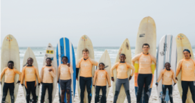 volunteers teaching children to surf in South Africa