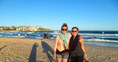 There’s so much to see out there – why wait! Travelers smile from Bondi Beach, Australia. 