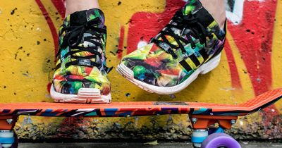colorful sneakers, colorful skateboard, and colorful painted background