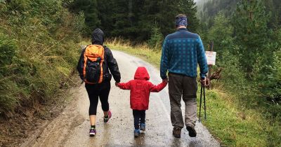 family hiking in the rain