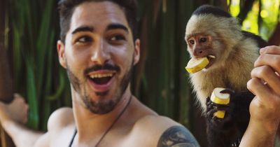 Man holding monkey in Costa Rica