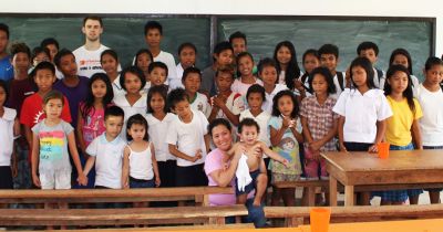 International teacher with students in the Philippines