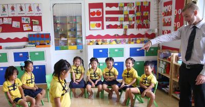 teacher leading a fun interactive exercise with his students