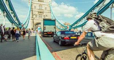 A man riding a bicycle on a bridge