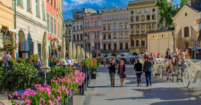 Krakow city center with pedestrians and a carriage