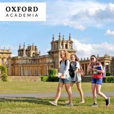 three students walk across a lawn at Oxford