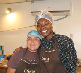 Two people wearing an apron and hair net