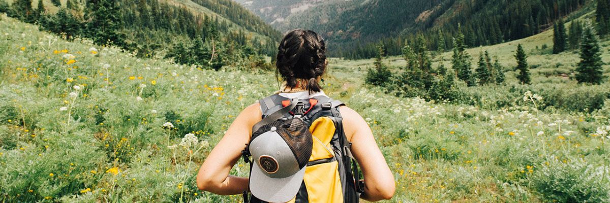 Girl with backpack going hiking