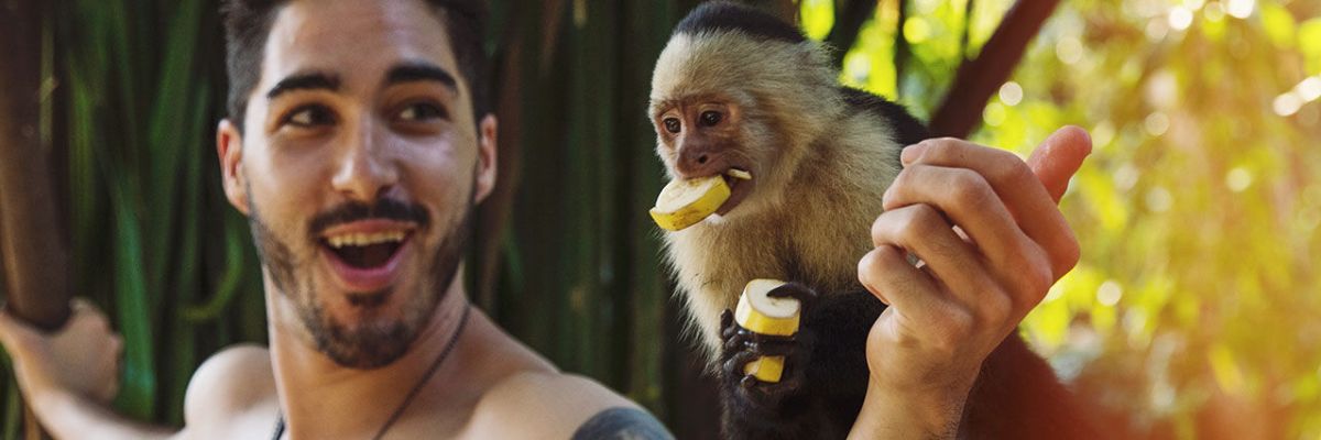 Man holding monkey in Costa Rica