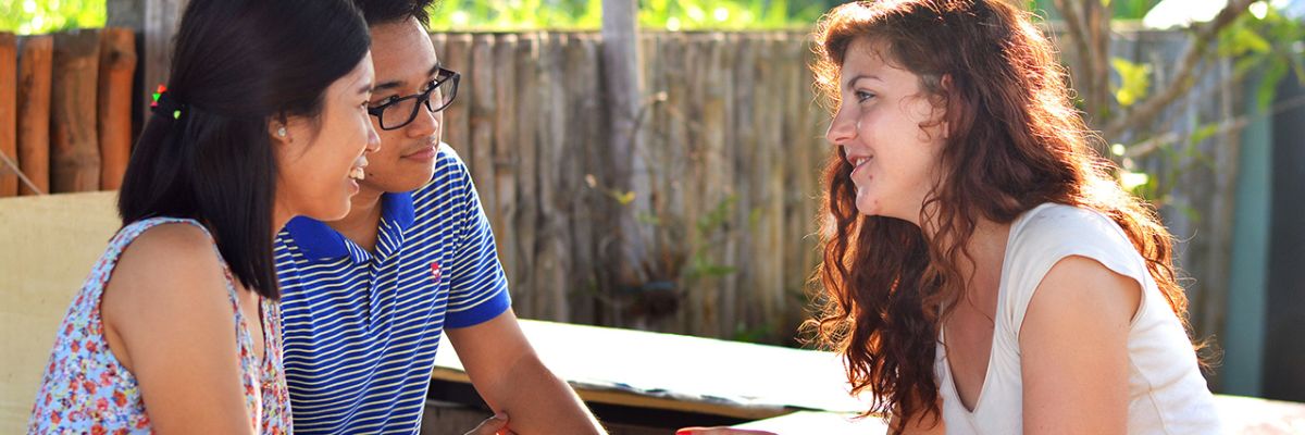 Friends talking at a picnic table