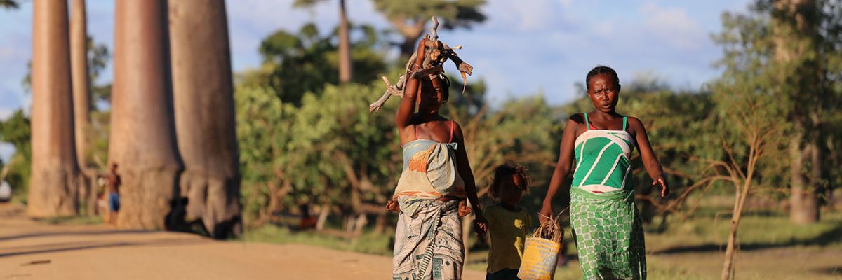 Women walking with children down road in Madagascar