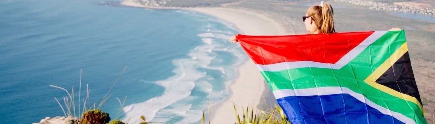 a girl holding a South African flag