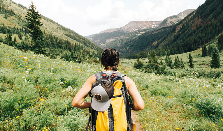 Girl with backpack going hiking