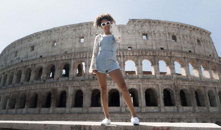 Woman taking a photo in front of Colosseum