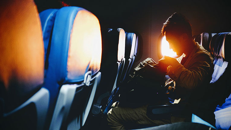 person sitting by window on plane
