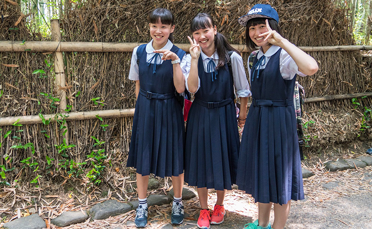 Three young Japanese girls in school uniforms