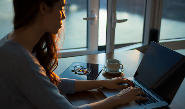 woman working on laptop early in the morning