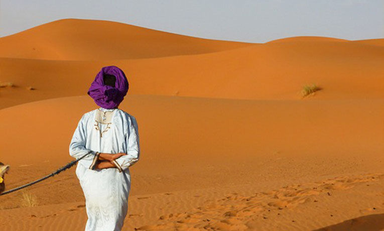 Woman walking in the Moroccan desert