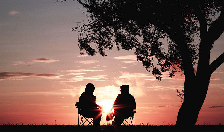 Two people watching sundown