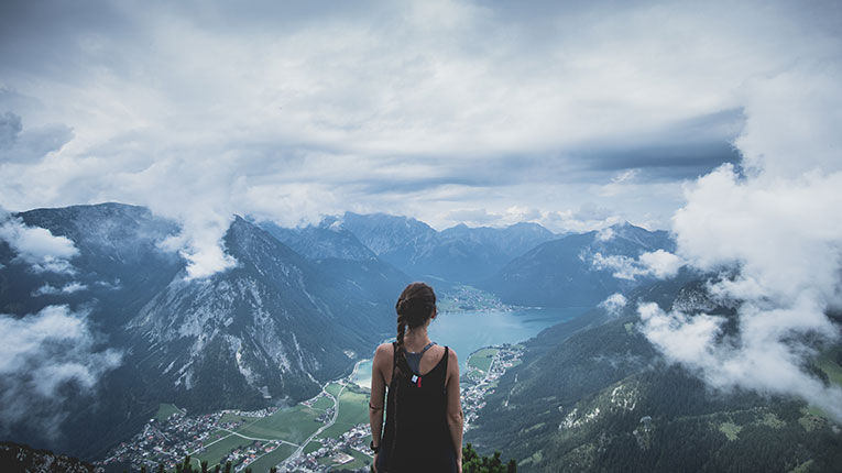 woman standing on mountaintop