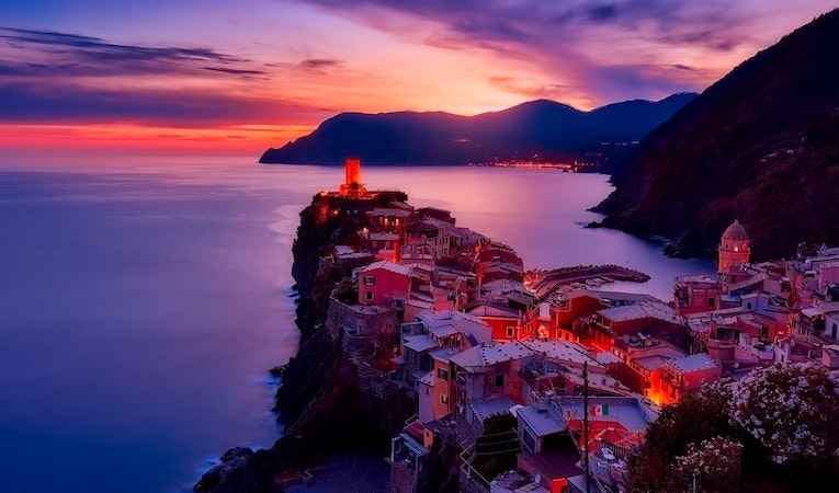 View of Italian villas on the water at dusk
