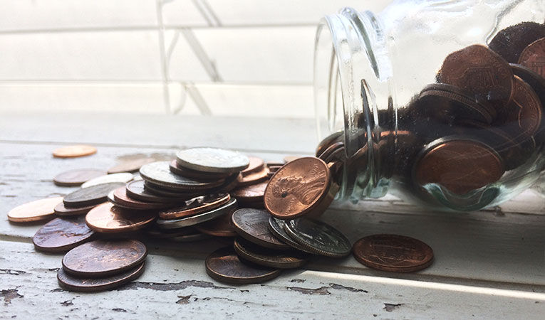 jar of change spilled out onto table