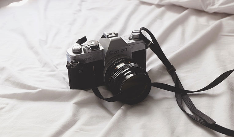 film camera on a bed