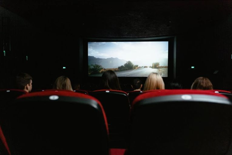 people in a theater watching a movie