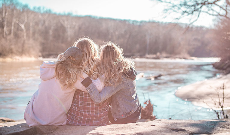 Three girls hugging