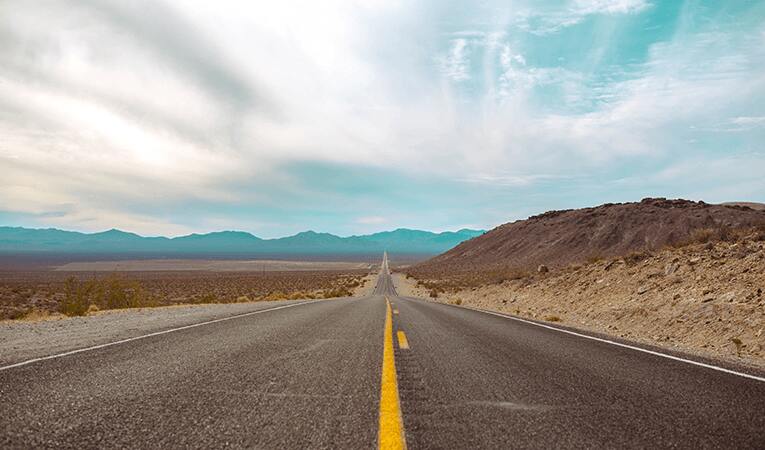 straight desert highway facing horizon