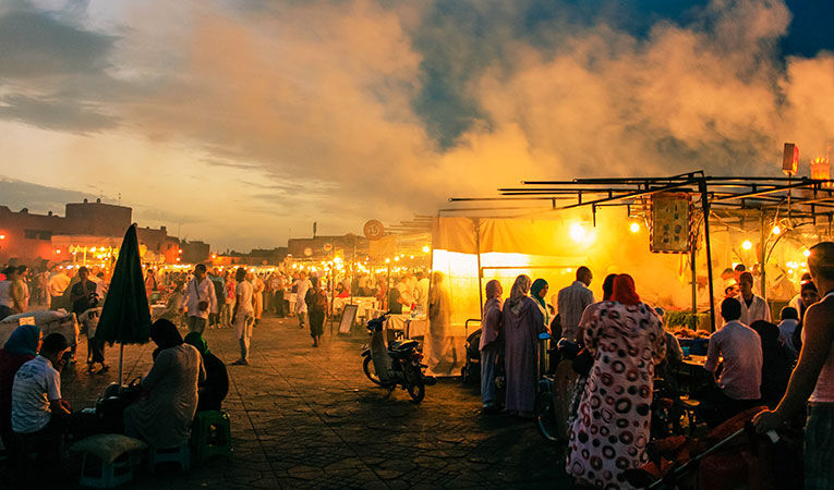 open air market lighting up at dusk