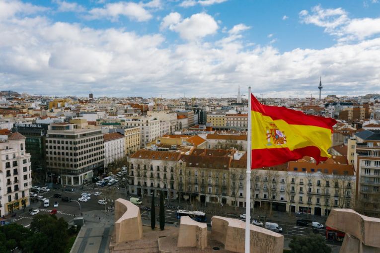  spain’s flag above a city scape