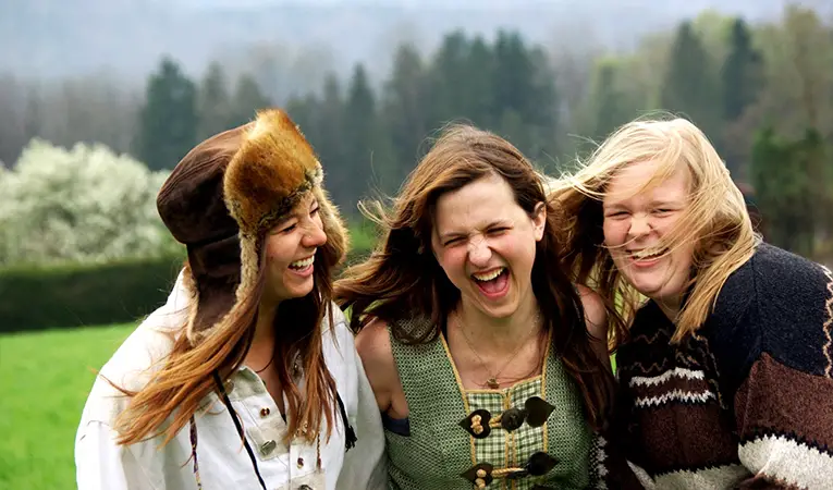Three girls laughing together