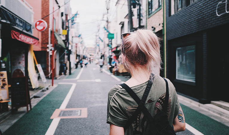 Girl walking down street in Japan