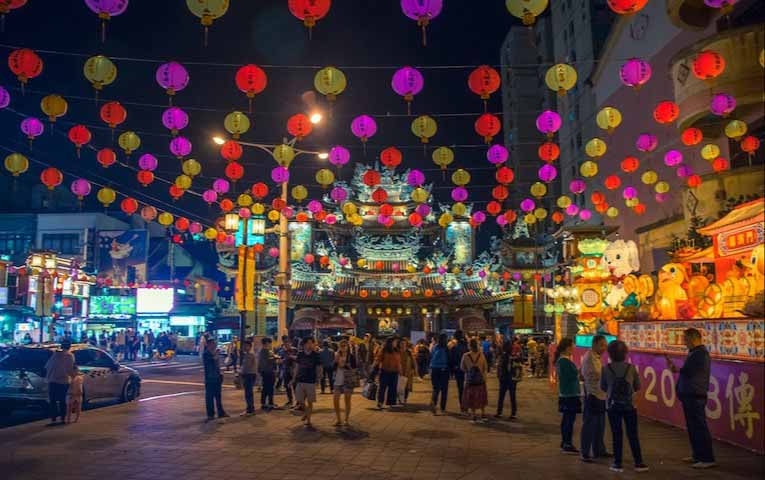 colorful lanterns hanging above crowd of people at night