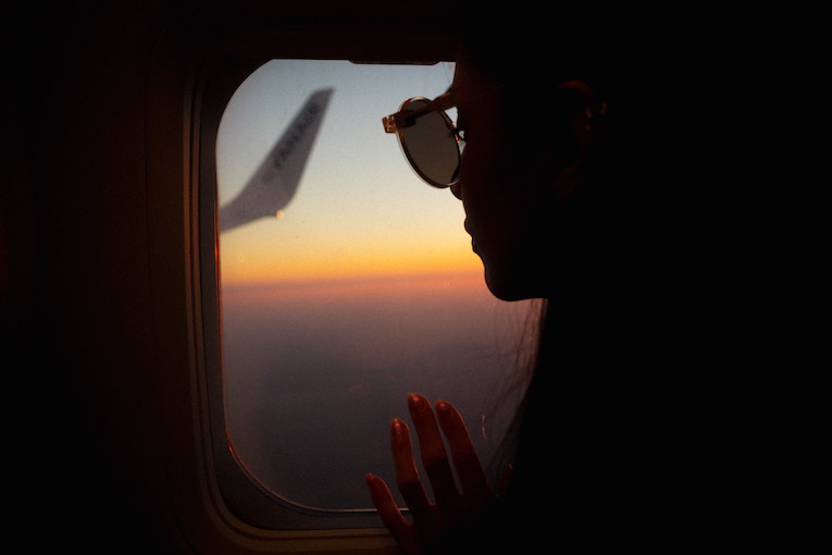 study abroad student looking out an airplane window
