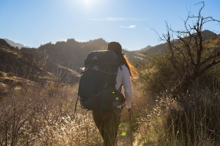 person trekking with a big backpack