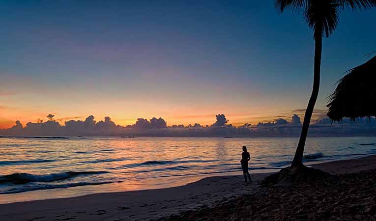 Punta Cana, Dominican Republic woman standing on the beach at sunrise