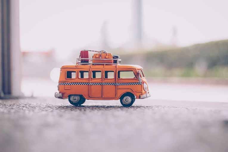 Miniature van with luggage strapped to the roof