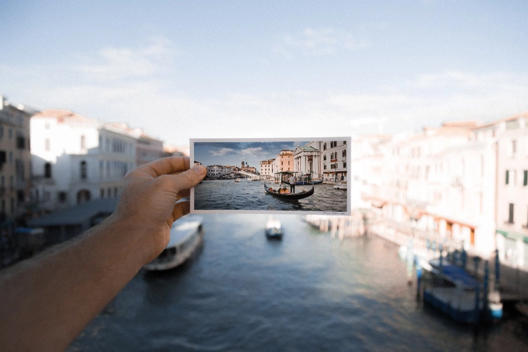 person holding photo of water in front of water