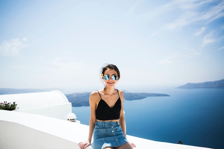 study abroad student posing on a roof top in fira, greece