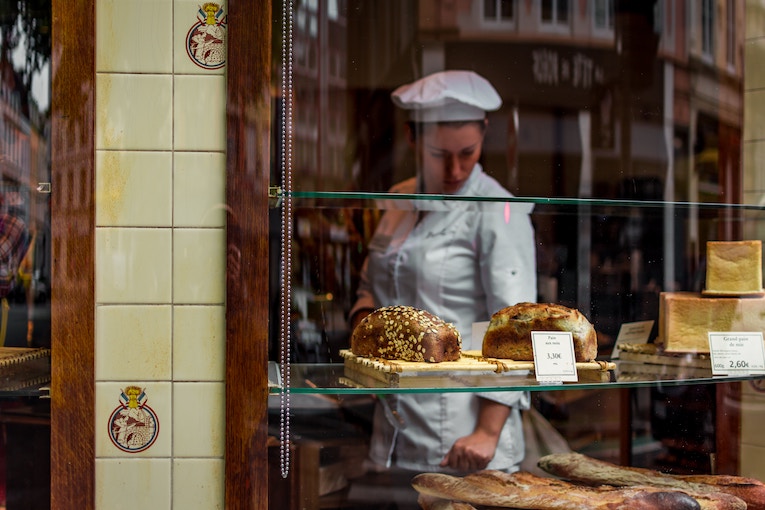 bread and baker behind glass window