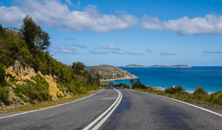 Road, sky, ocean, rocky coastline in Wilsons Promontory, Australia