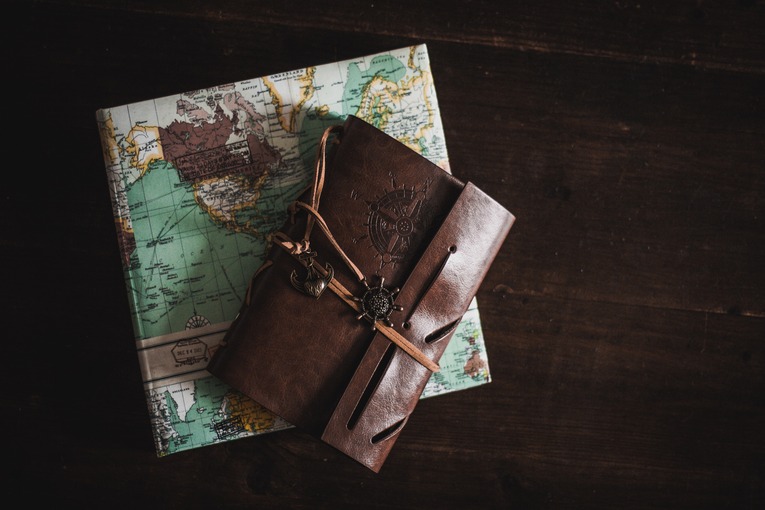 A leather journal and a travel diary