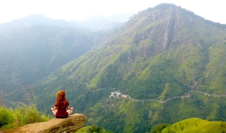 woman sitting on a rock in sri lanka