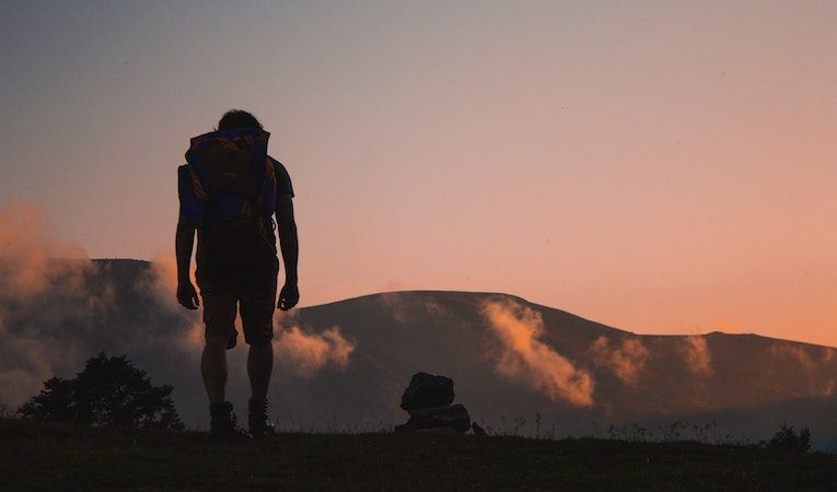 person hiking at sunrise