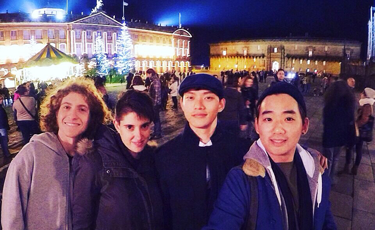 four guys in the city square at night