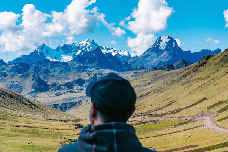 person standing facing mountains