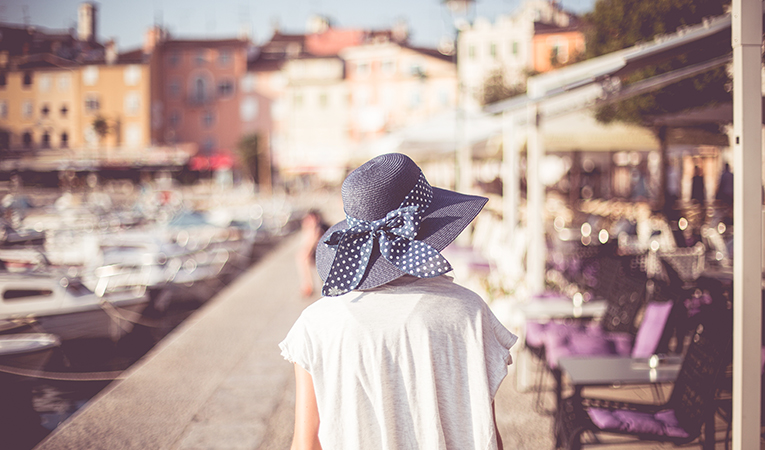 woman with a sun hat near the docks