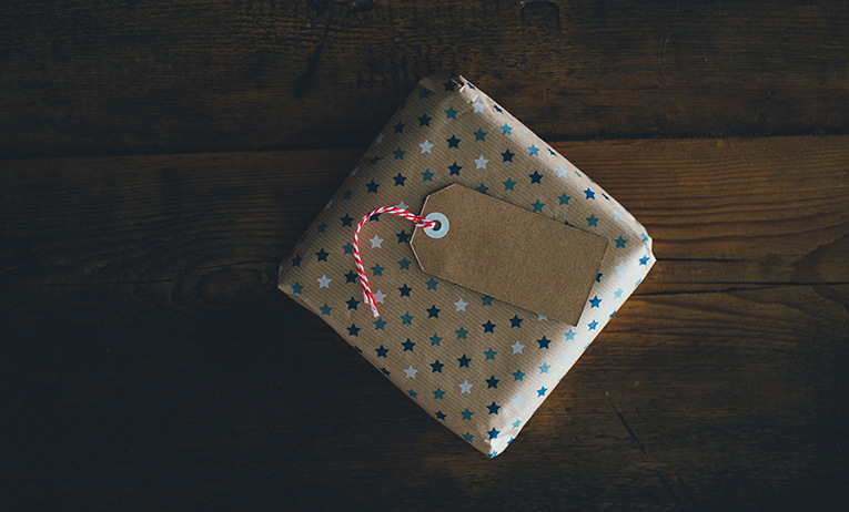 Small wrapped gift with blue and white stars on the wrapping paper